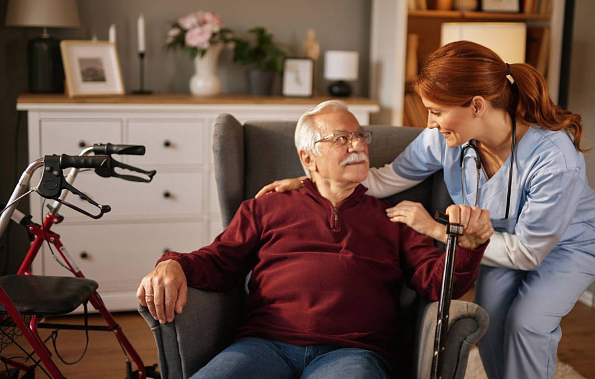care nurse at home with a patient